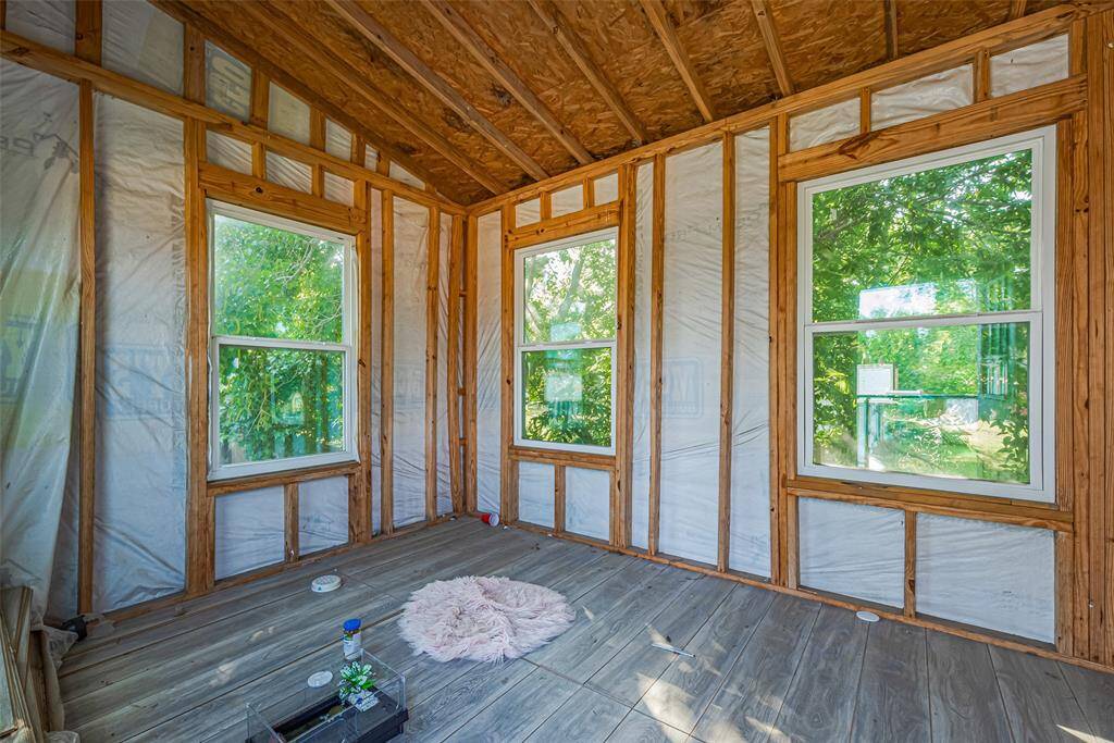 Off the pool area, there is a playhouse with a rock wall entry.