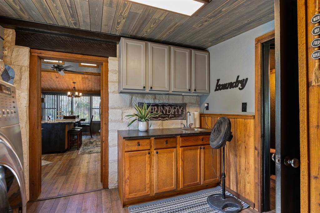 Laundry room with onyx leather countertops.
