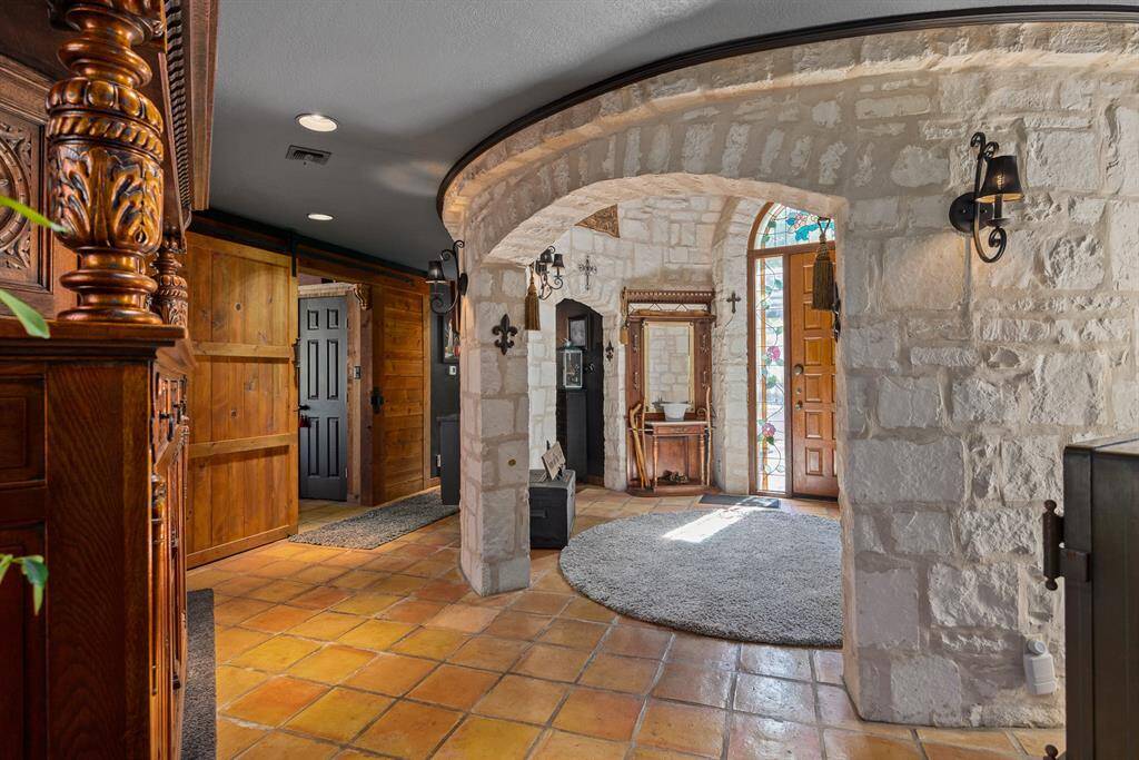 back into the hallway behind the round stone foyer.