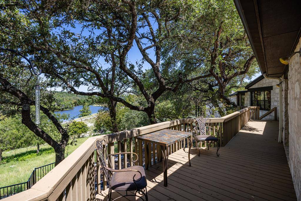 Sliding doors lead to the veranda overlooking the lakeview & the rolling hills.