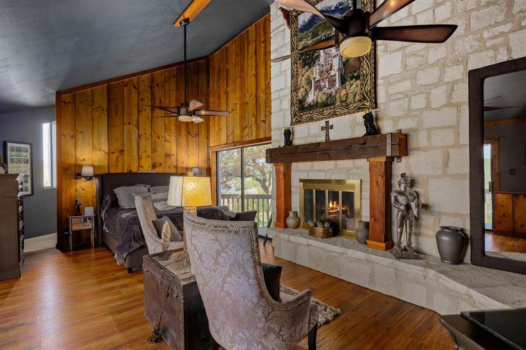 Primary bedroom with custom gas-log fireplace.