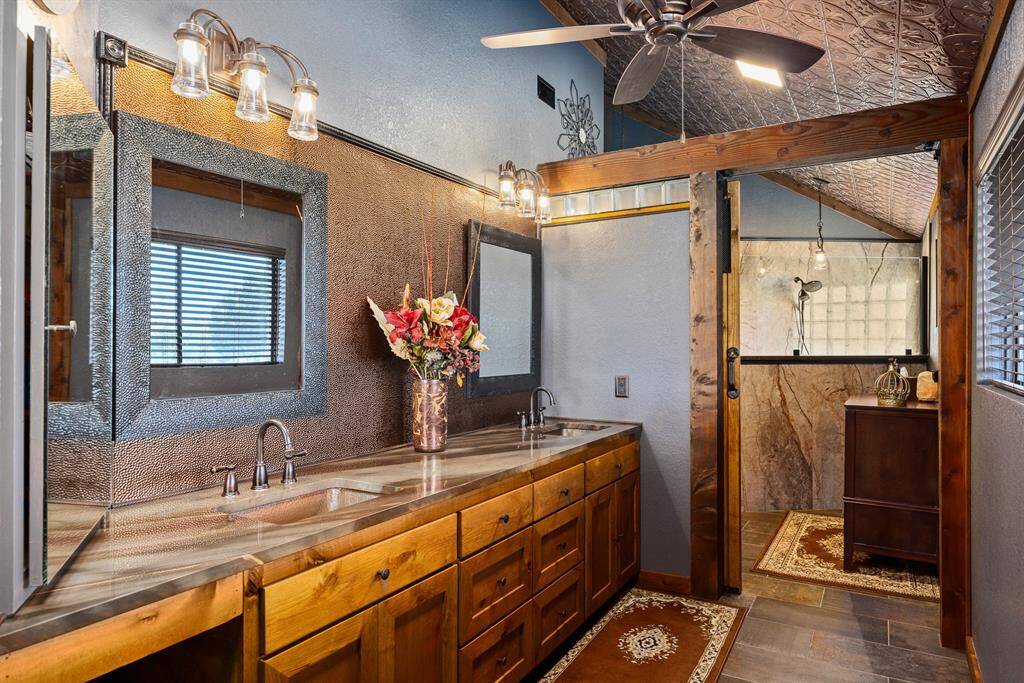 Primary bathroom with matching luxurious granite countertops.