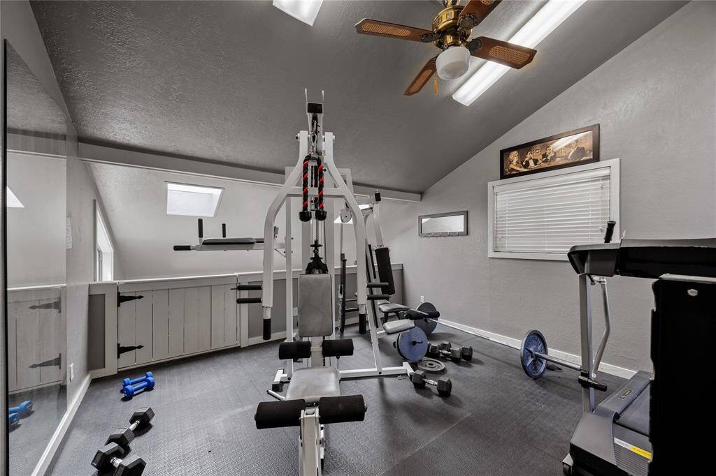 Game room where is set up as a gym on 2nd level.