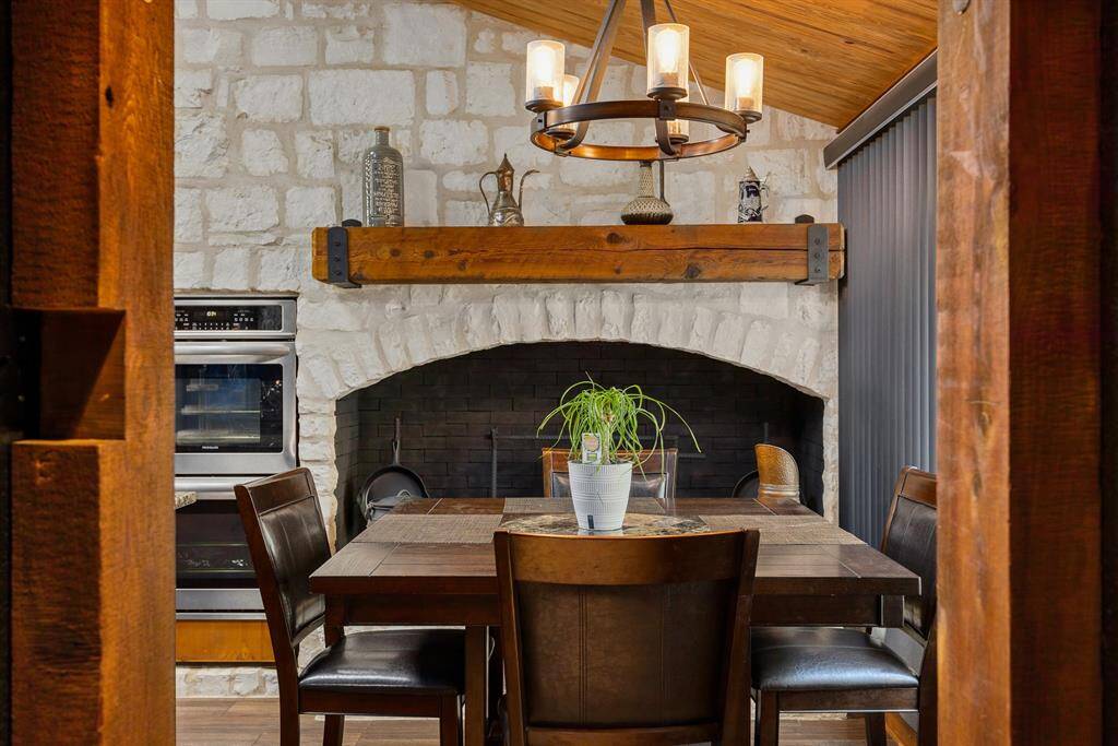 Make a right into the kitchen, beakfast area with wood-burning fireplace (sitting hearth & solid cedar mantle.