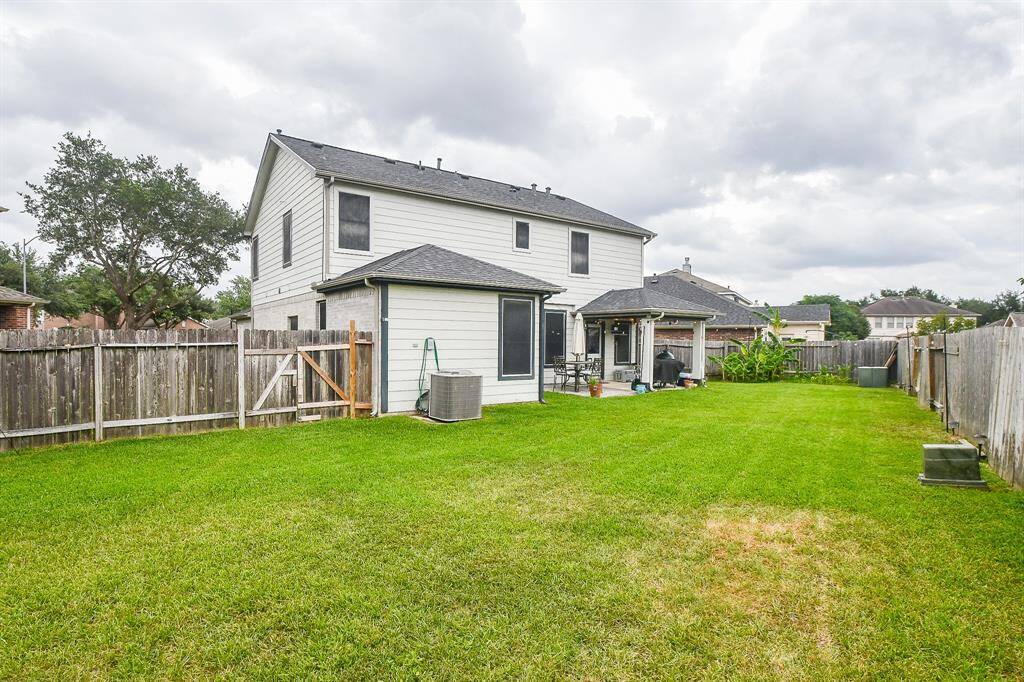 This photo shows a spacious backyard with well-maintained grass