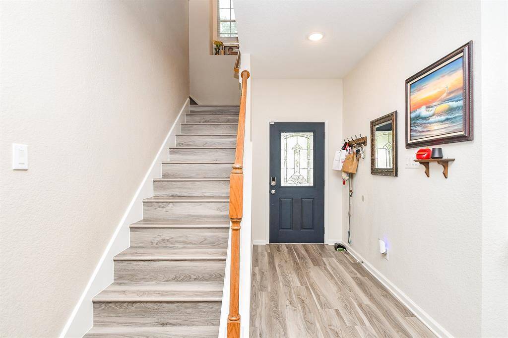 Bright entryway with the staircase leading upstairs