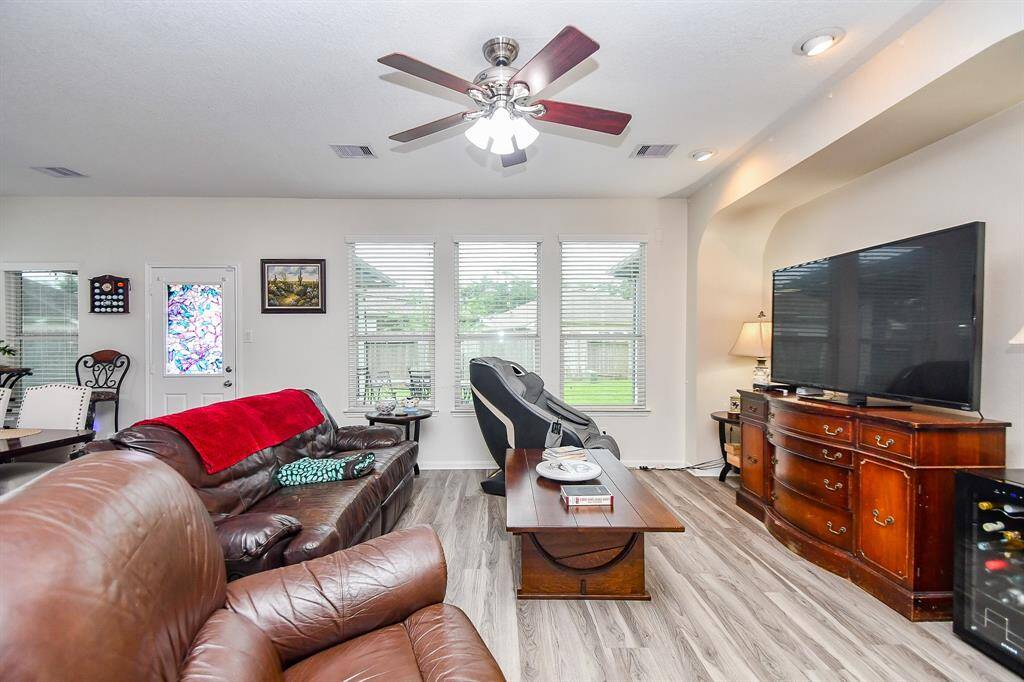 This inviting living room is ready for family movie nights. Natural light floods in through multiple windows