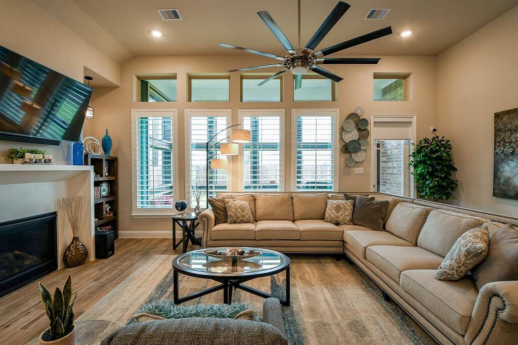 High ceilings and windows from floor to ceiling make this family room a great hang out space!