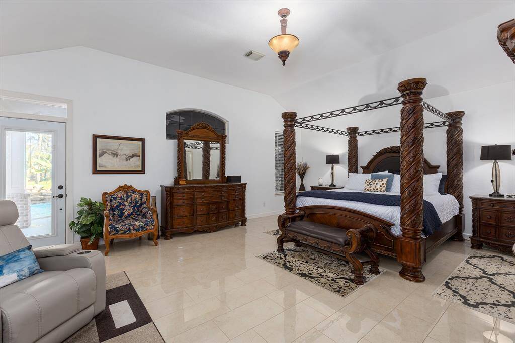 Primary Suite With Sitting Area and Access Door To The Pool