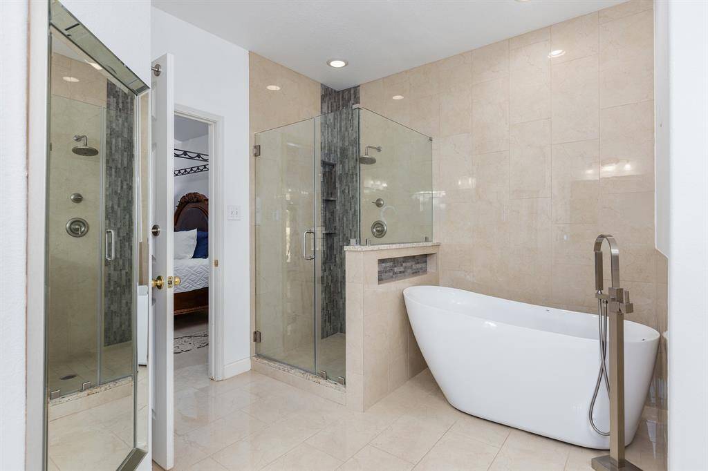 Updated Primary Bath With Beautiful Tile Work, Built-in Niches, and Freestanding Soaking Tub