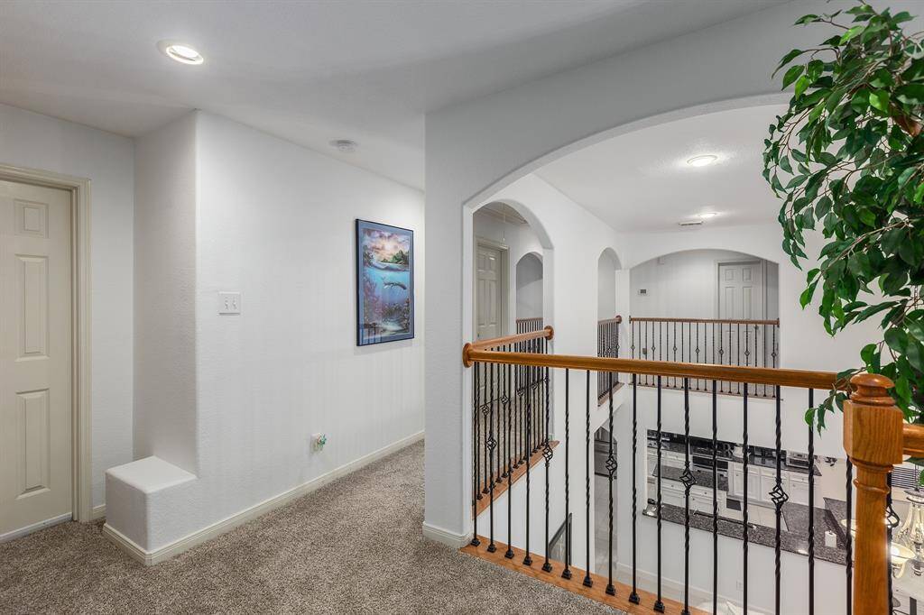 Tile and Wood Flooring Throughout.  Carpet Only in Media Room and Upstairs Hallway (Replaced 2023).