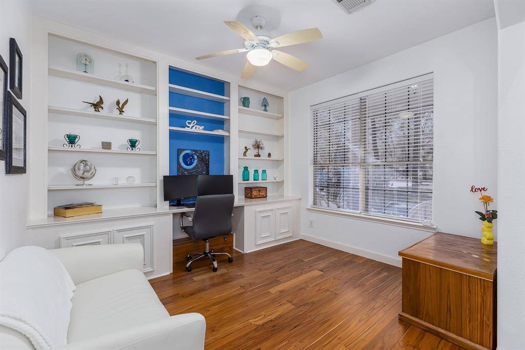 Home Office with Built-in Shelves and Teak Wood Floor