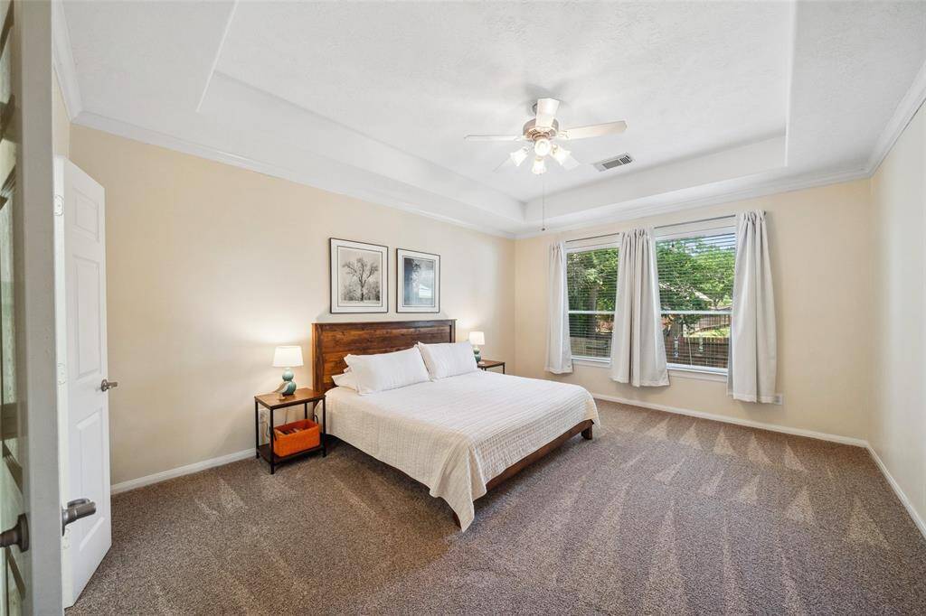 Large primary bedroom with large windows