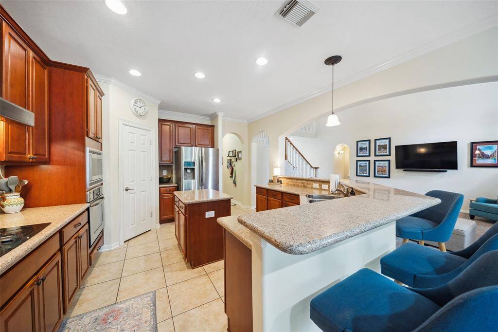 Large eat at bar in kitchen with walk in pantry and separate island