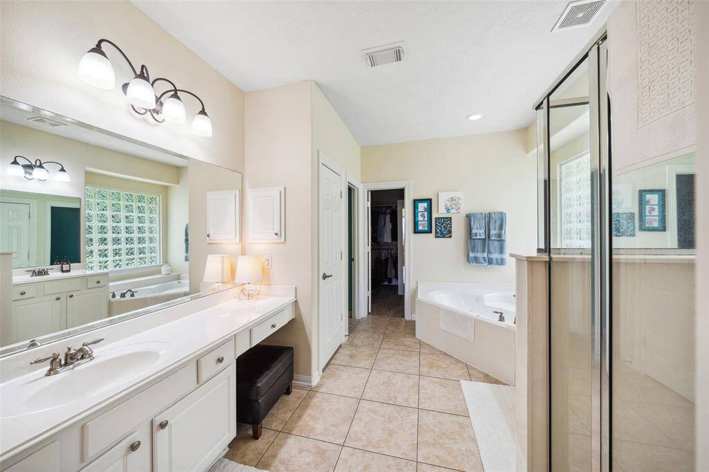 Large bath with vanity area and large walk in closet