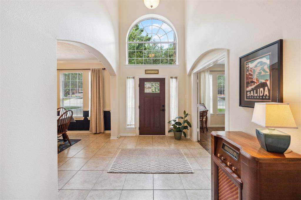 Formal 2 story entrance with gorgeous wood front door