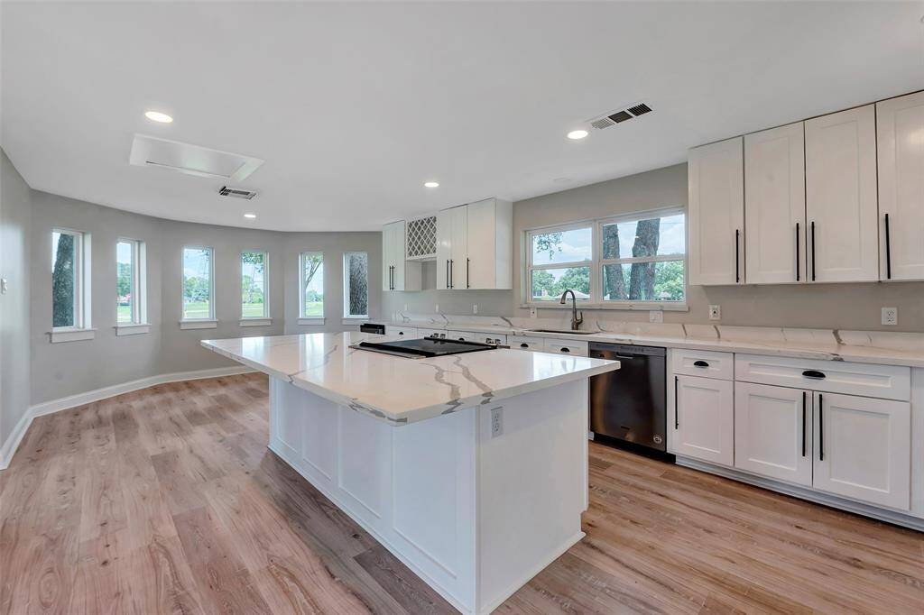 A chef's dream kitchen with Quartz countertops and a convenient center island. Add your own bar stools to create additional seating space.