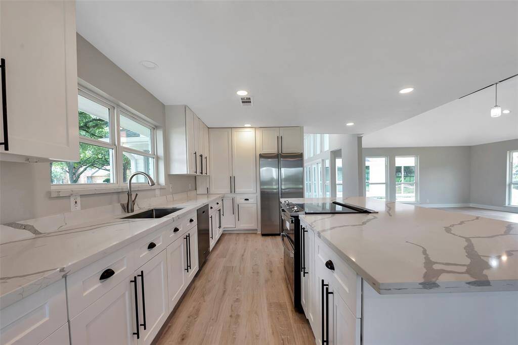Stainless steel appliances include a Maytag dishwasher, side by side refrigerator, 5 burner induction range with convection air fryer / oven, Zephyer down draft venthood - all 2024. Dishwasher has a 10 year warranty.