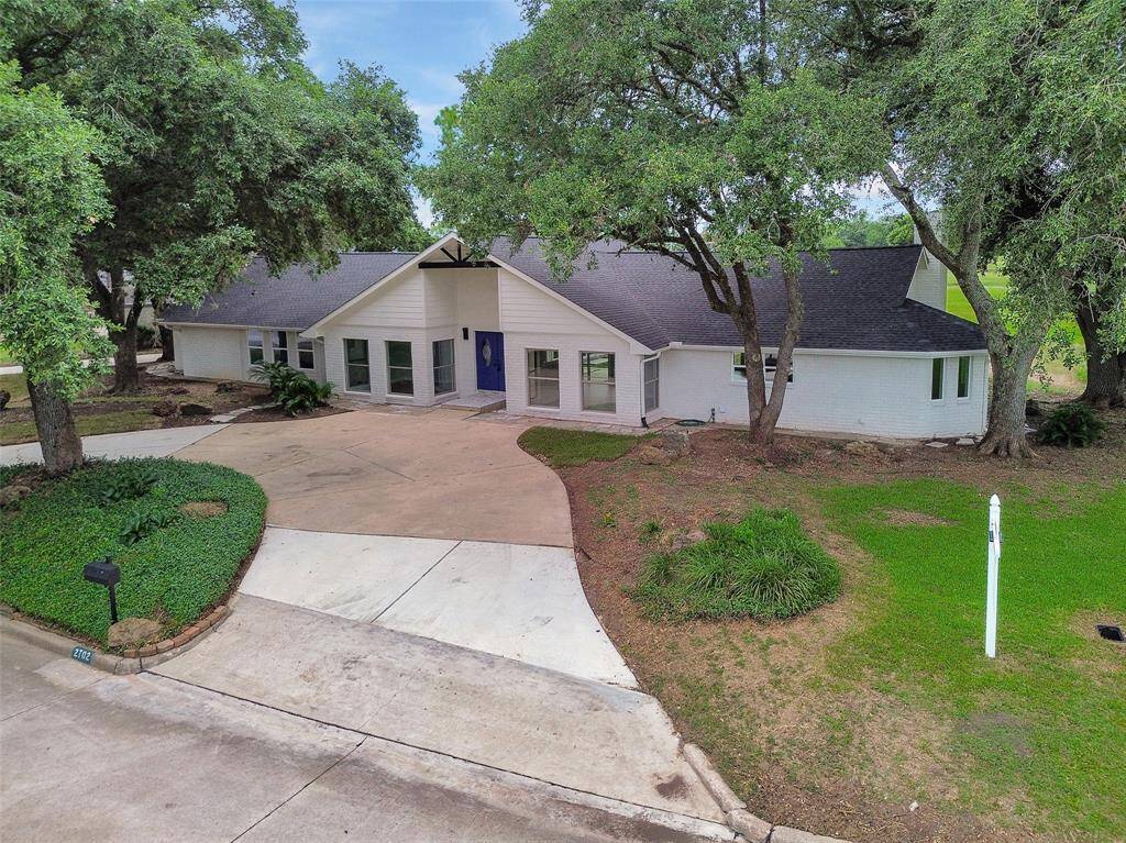 Mature shade trees frame the home beautifully!