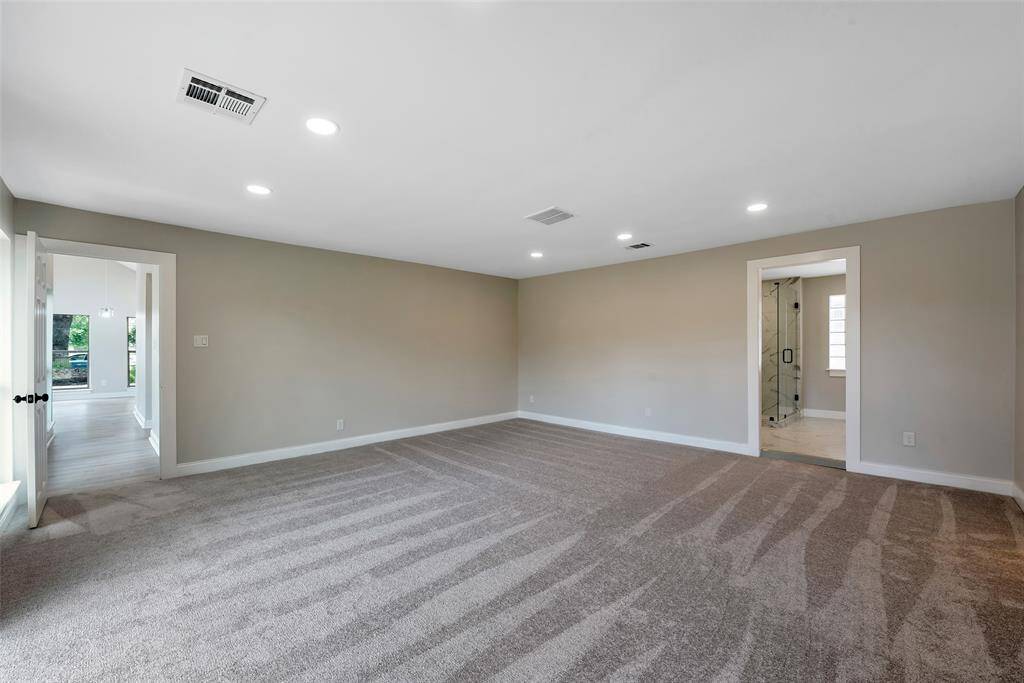 Primary bedroom and entry to private bathroom.