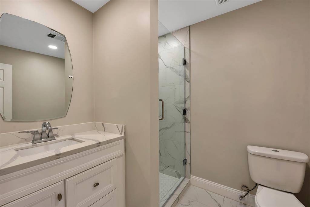 Bathroom - also been completely updated with designer mirror, new toilet, large porcelian tiles, a new vanity and light fixtures. All plumbing hardware and fixtures were replaced as well - 2024.