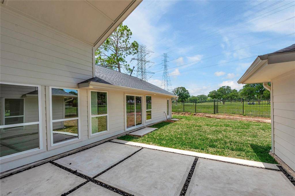 Contemporary large 'squared' patio with gravel in between overlooks the golf course!