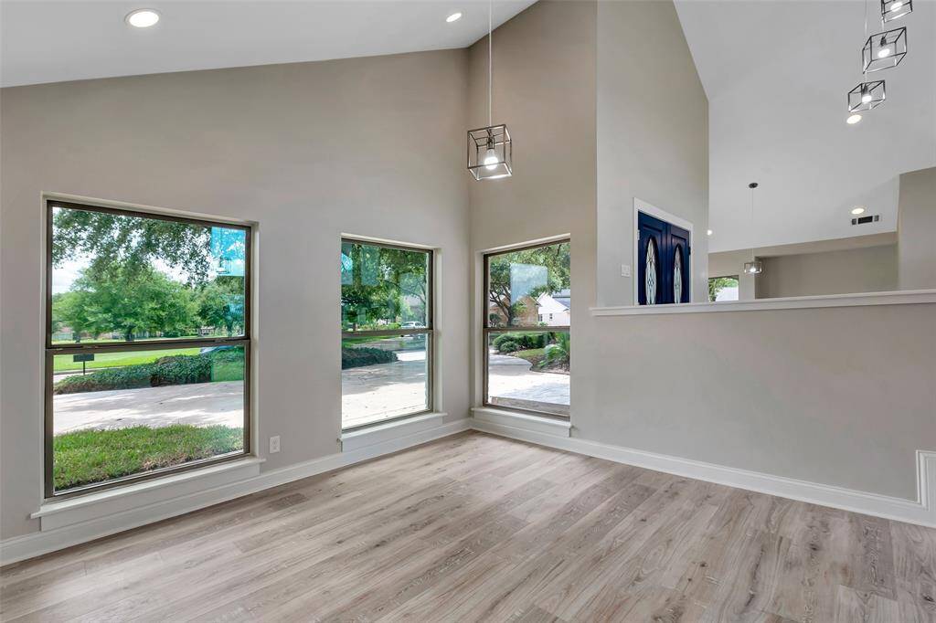 Spacious formal dining room with modern light fixture (matching with ones found in the kitchen) and dramatic large "picture" windows - for making the most of your views!