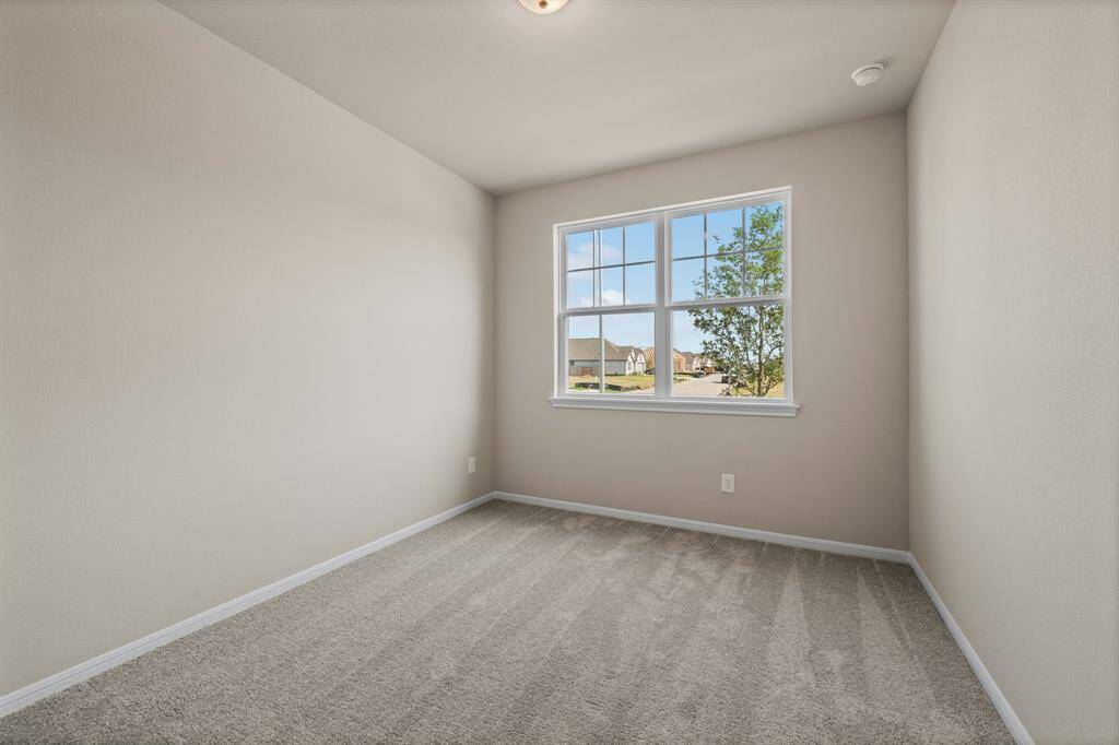Your secondary bedroom features plush carpet, fresh paint, closet, and a large window that lets in plenty of natural lighting.