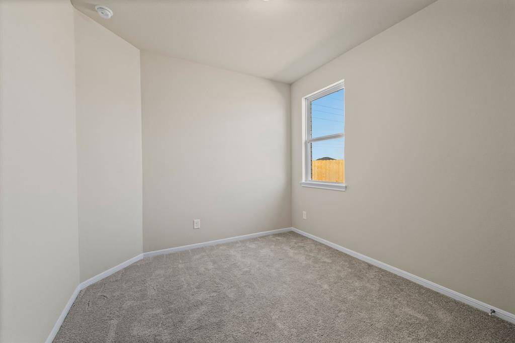 Your secondary bedroom features plush carpet, fresh paint, closet, and a large window that lets in plenty of natural lighting.