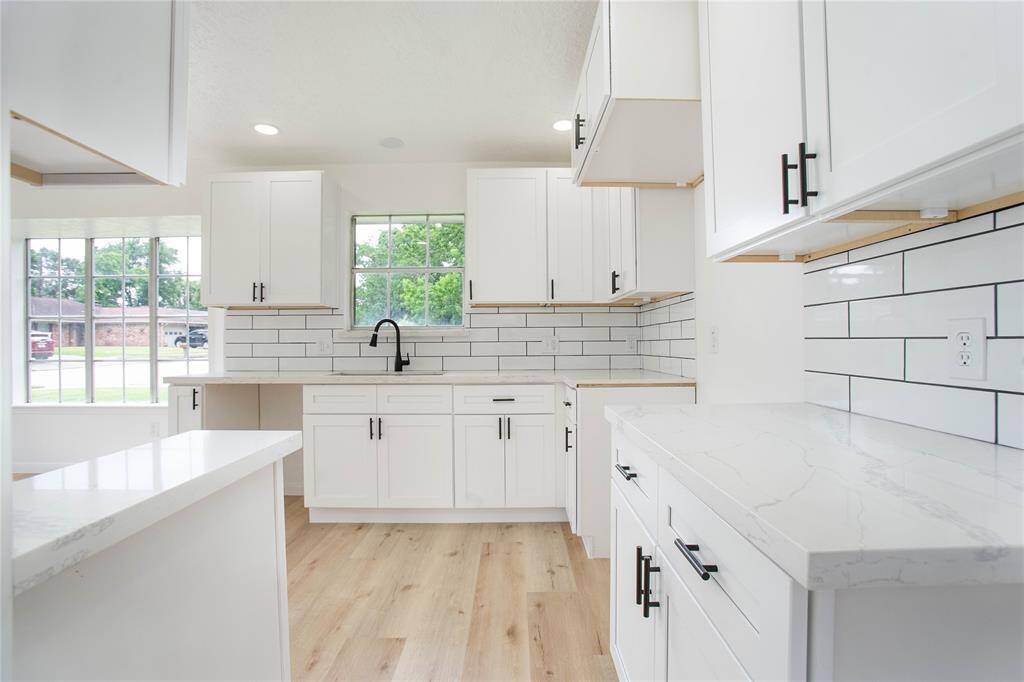 Fully remodeled kitchen with new cabinetry, 2cm Quartz countertops, sink, backsplash, and new trash disposal!