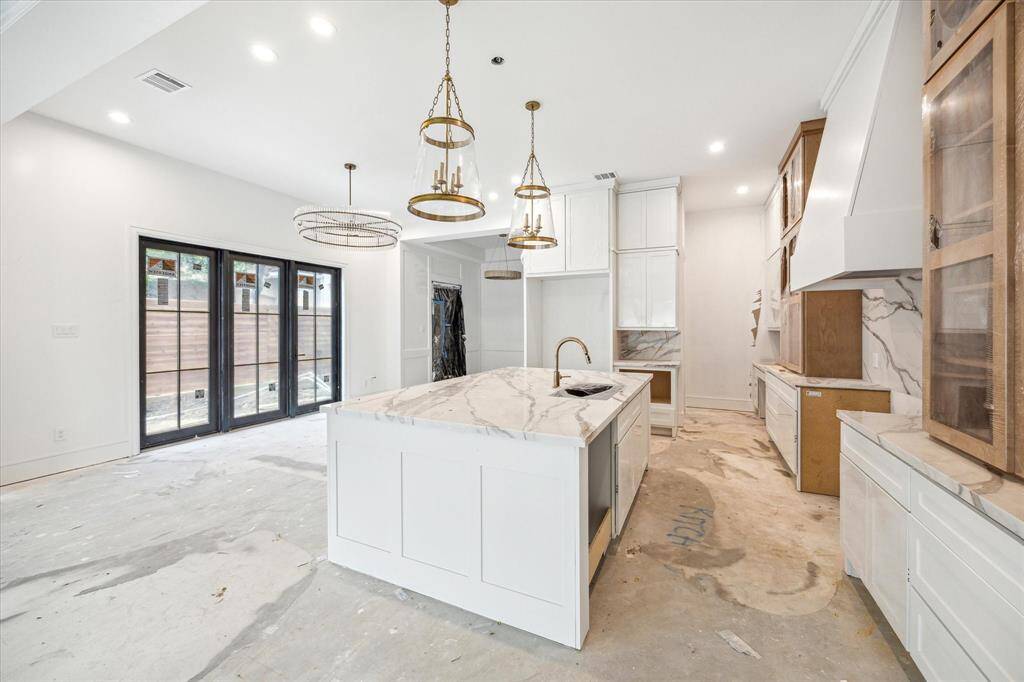 At the back of the kitchen is a built-out pantry with White Oak shelving and sit-in planning center.