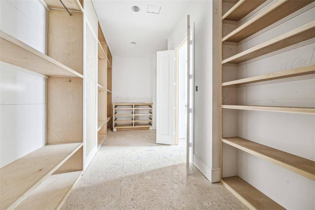 Primary to feature fully built-out wardrobe.