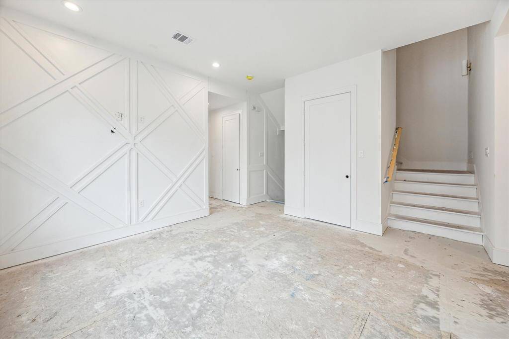 Custom millwork and sconces featured along stairways.