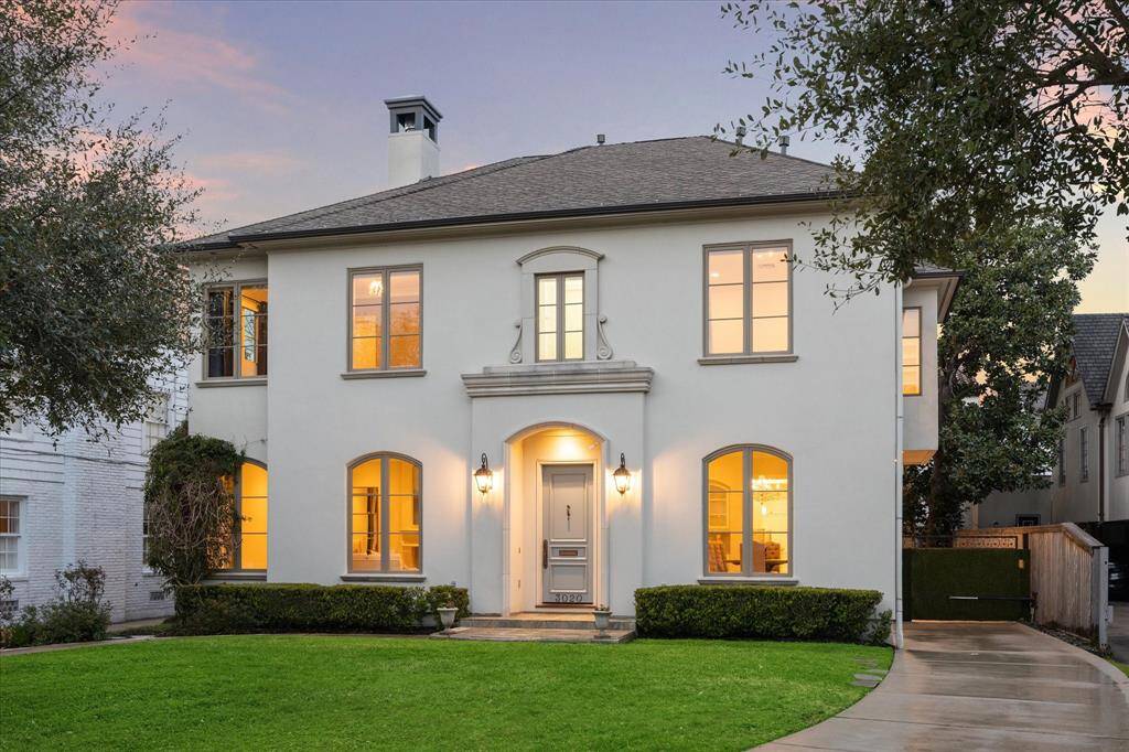 Welcome to 3020 Ella Lee. This elegant two-story home features a classic facade with arched windows and a welcoming front entrance.