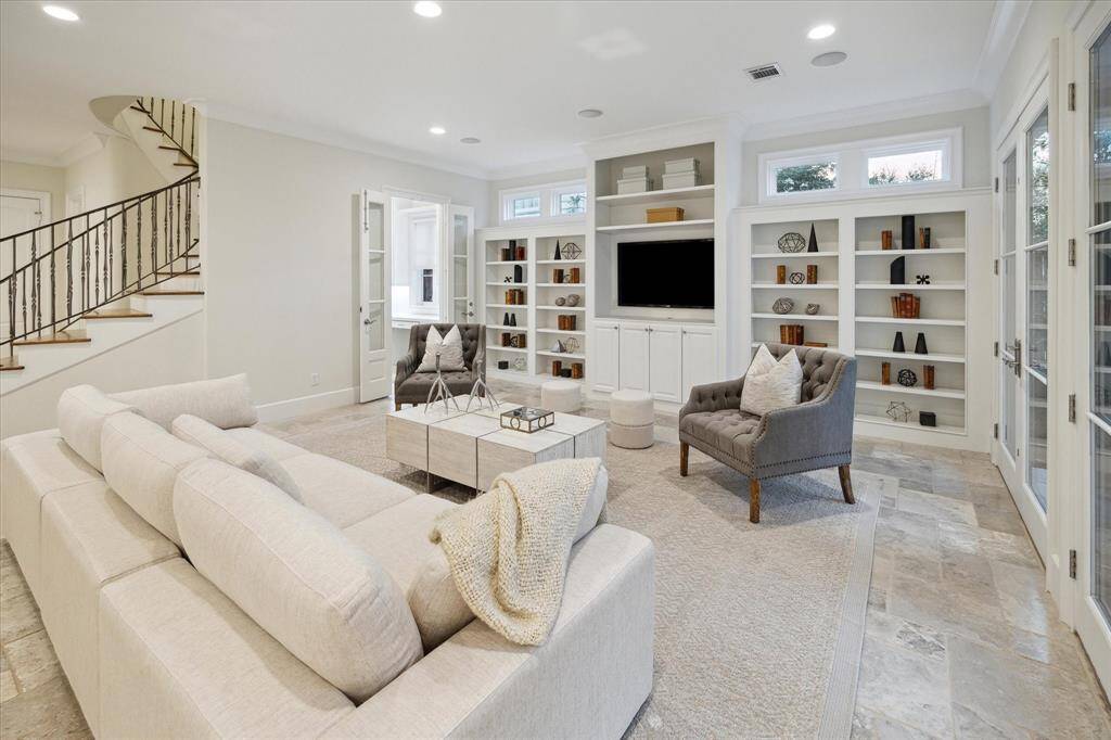 The spacious open-concept family room creates the ideal spot for casual living with great display bookcases.
