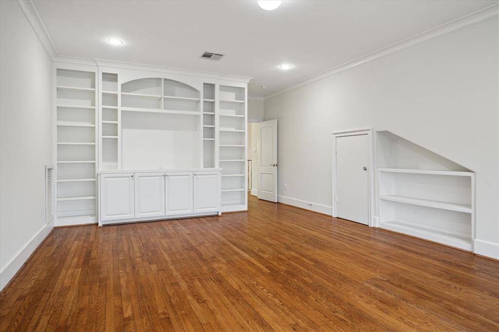 Explore the third-floor game room, featuring a built-in entertainment center and bookcase.