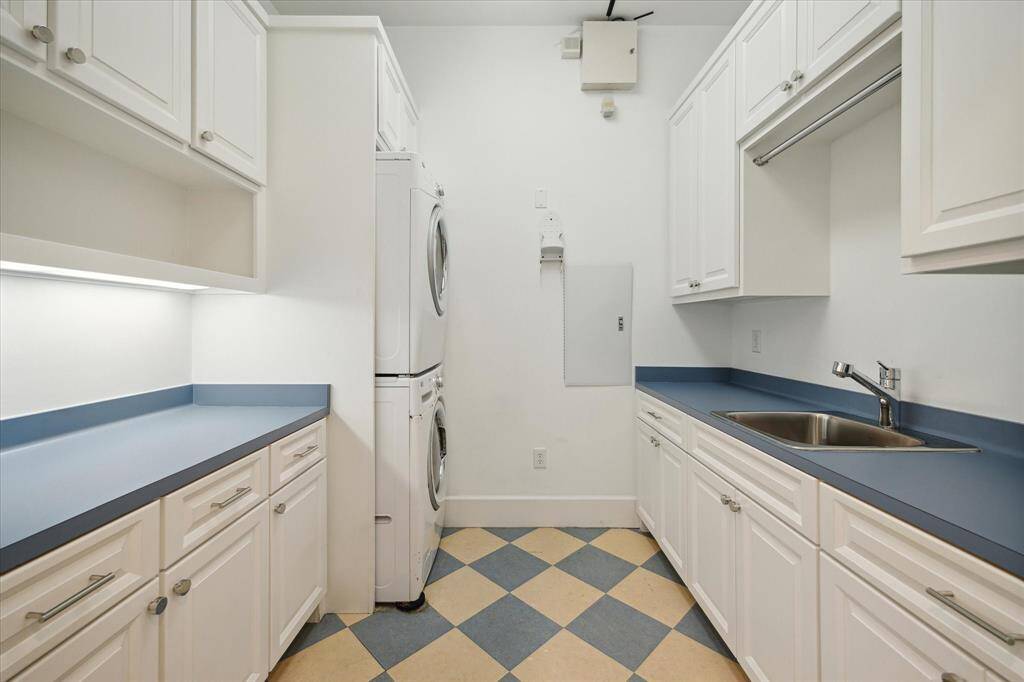 The second-floor utility room, featuring generous counter space, abundant storage, and a convenient utility sink.