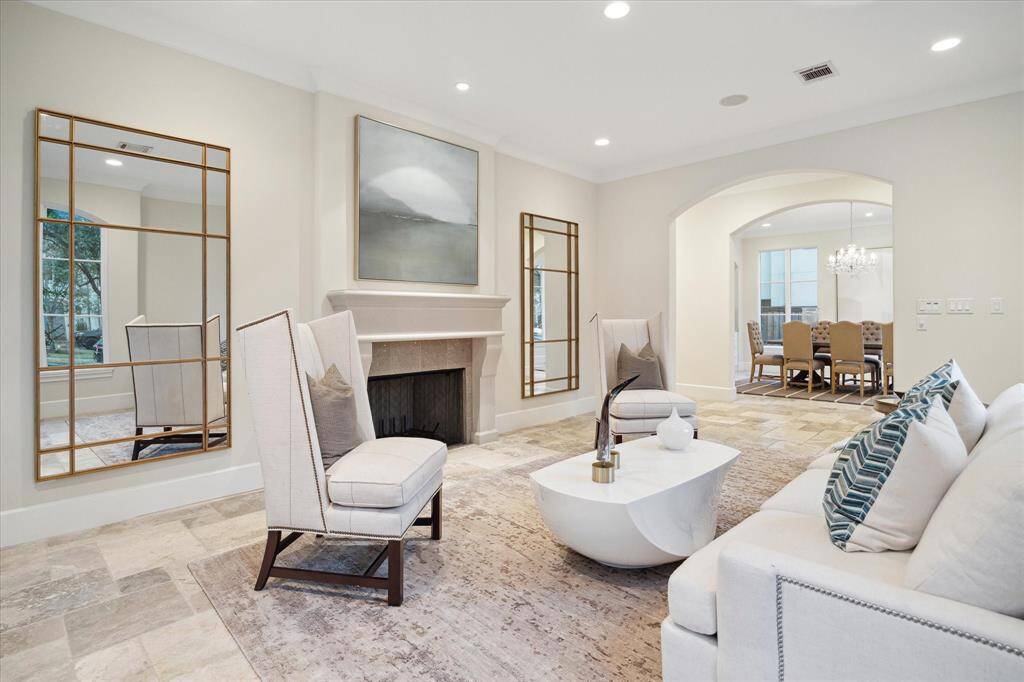 The formal living room with a chic fireplace that centers the room creates a cozy yet sophisticated ambiance.