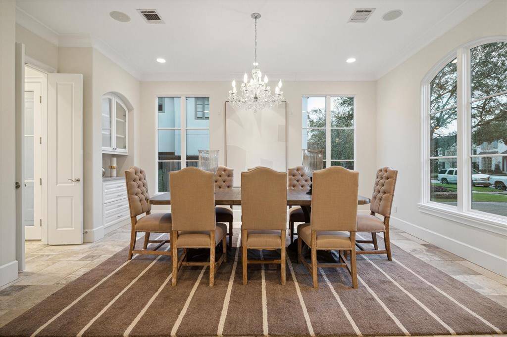 This spacious dining room with ample natural light from two large windows is perfect for dinner parties.
