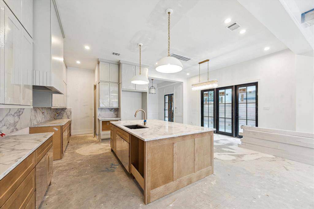 At the back of the kitchen is a built out pantry with White Oak shelving and sit-in planning center.