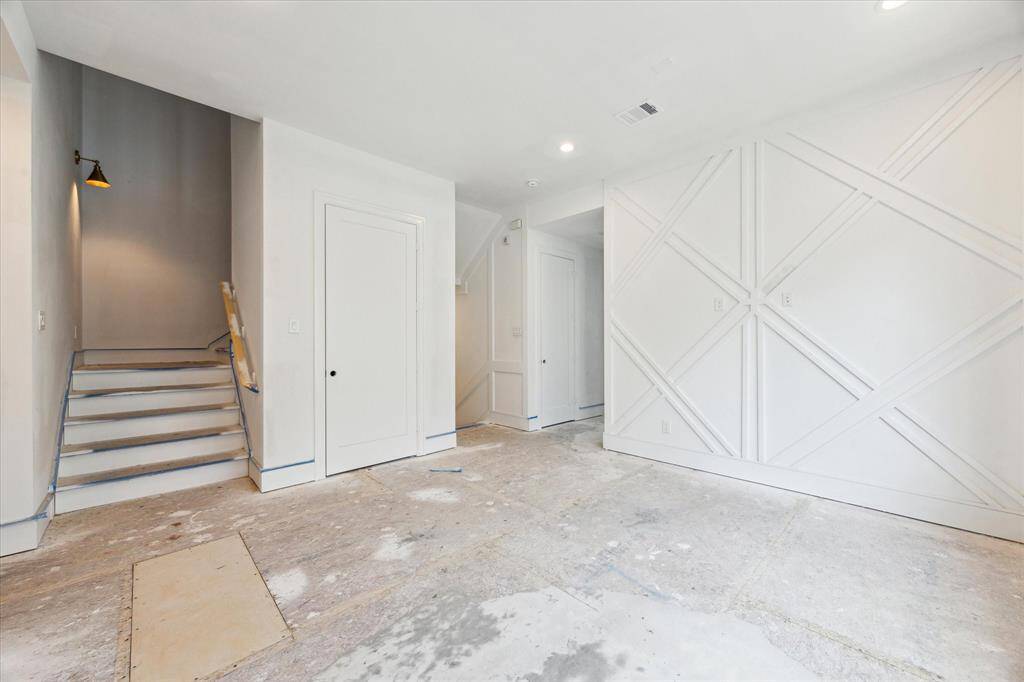 Custom millwork and sconces featured along stairways.