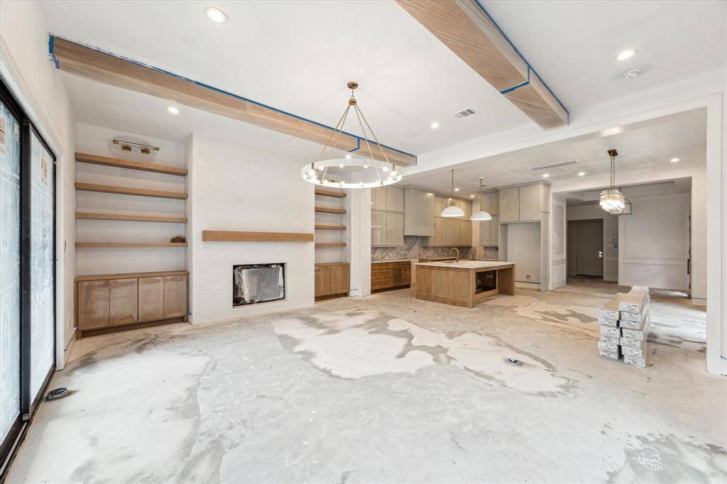 Abundant windows and 11-foot ceilings on the first floor fill this space with natural light.