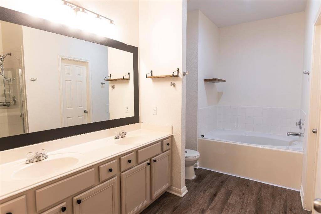 Primary bathroom with two sinks, soaking tub and a HUGE walk-in closet.