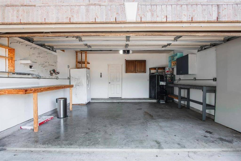 Garage features several built-ins and a tool bench .