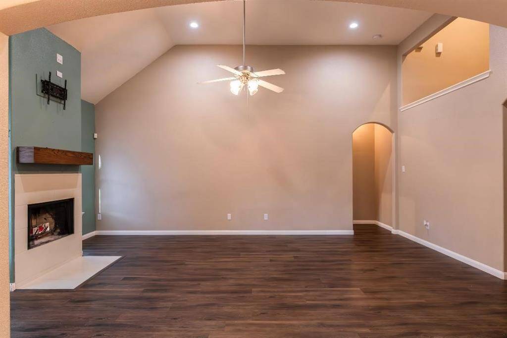 Huge two-story living room with gas/wood burning fireplace and a custom mantel.