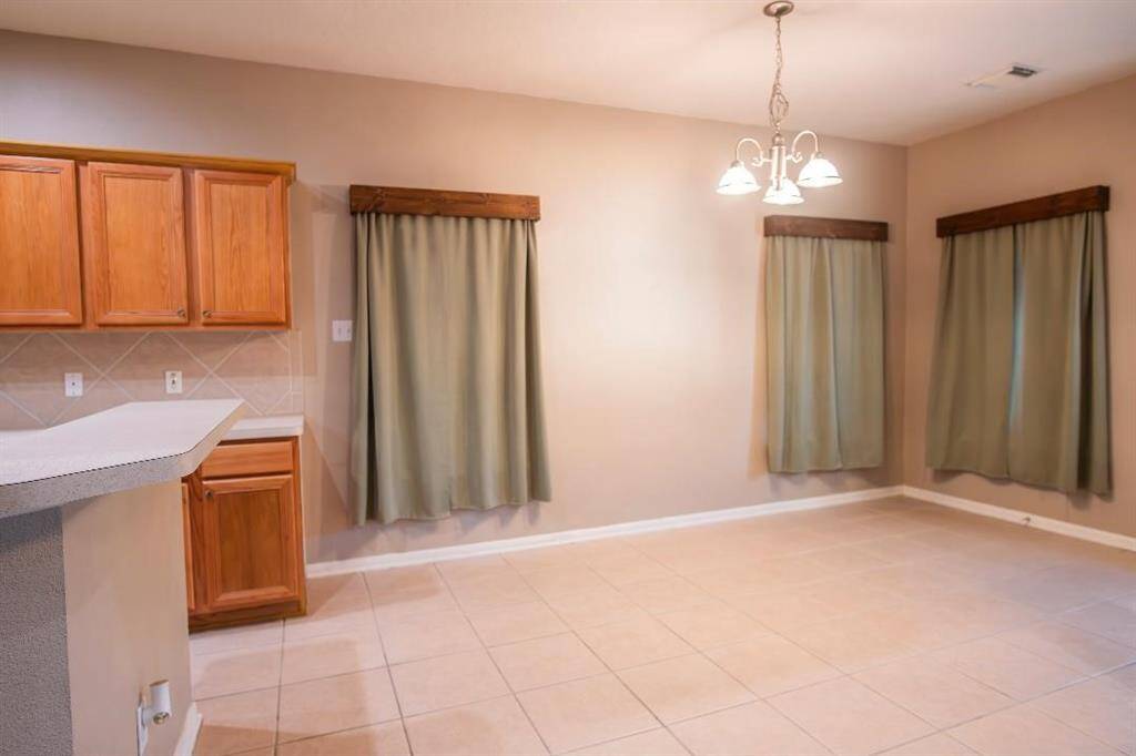 Breakfast room off the kitchen with a large bar perfect for entertaining .