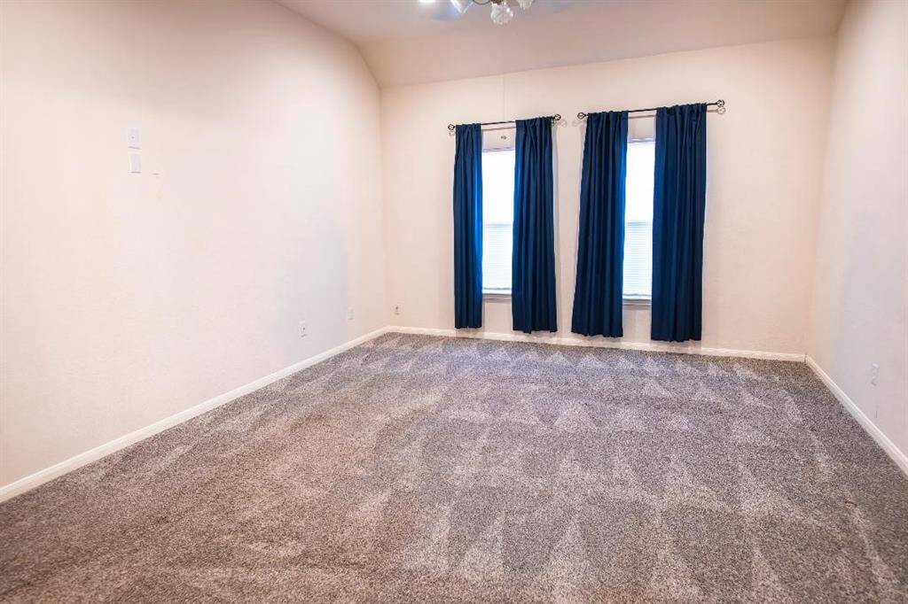 Primary Bedroom is off the living room featuring high ceilings and large windows.