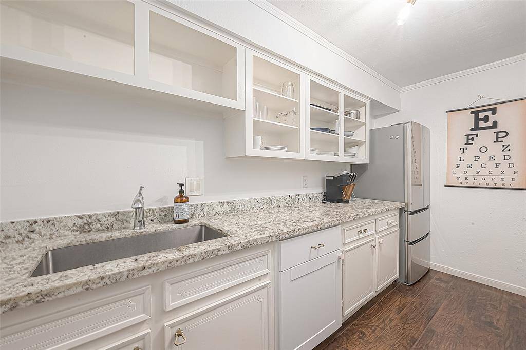 Huge deep stainless steel sink and richly appointed faucet.