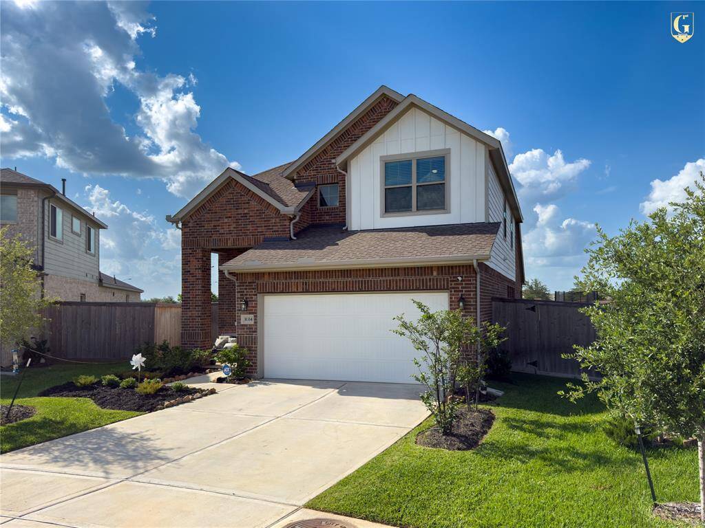 Front elevation with Knights Armor trim and Ghost Writer accents on a full brick façade. Built by Chesmar Homes with a two-car garage and located on a quiet cul-de-sac in Dellrose.
