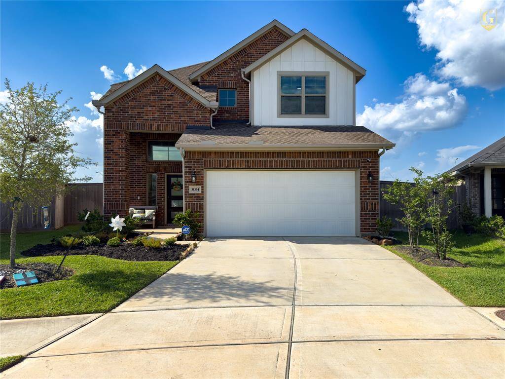Front elevation with Knights Armor trim and Ghost Writer accents on a full brick façade. Built by Chesmar Homes with a two-car garage and located on a quiet cul-de-sac in Dellrose.